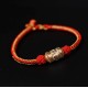 The red string is a symbol of protection, warding off negative energy, and attracting good fortune