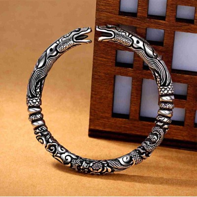 The dragon symbolizes strength and protection, while the silver promotes personal empowerment