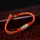 The red string is a symbol of protection, warding off negative energy, and attracting good fortune The red string is a symbol of protection, warding off negative energy, and attracting good fortune