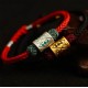 The red string provides good luck and protection against negative energy