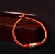 The red string is a symbol of protection, warding off negative energy, and attracting good fortune