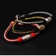The red string is a symbol of protection, warding off negative energy, and attracting good fortune