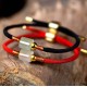 Aventurine attracts prosperity and the red string enhances confidence and positive energy