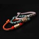 The red string is a symbol of protection, warding off negative energy, and attracting good fortune The red string is a symbol of protection, warding off negative energy, and attracting good fortune
