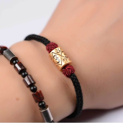 The red string provides good luck and protection against negative energy