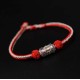 The red string is a symbol of protection, warding off negative energy, and attracting good fortune