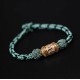 The red string is a symbol of protection, warding off negative energy, and attracting good fortune