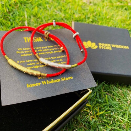 The red string brings good luck and protection, aligned with Tibetan Buddhist teachings The red string brings good luck and protection, aligned with Tibetan Buddhist teachings