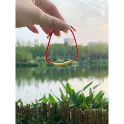 The red string brings good luck and protection, aligned with Tibetan Buddhist teachings
