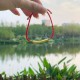 The red string brings good luck and protection, aligned with Tibetan Buddhist teachings The red string brings good luck and protection, aligned with Tibetan Buddhist teachings