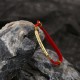 The red string brings good luck and protection, aligned with Tibetan Buddhist teachings The red string brings good luck and protection, aligned with Tibetan Buddhist teachings