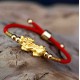 The red string and Pixiu attract wealth, good fortune, and financial prosperity