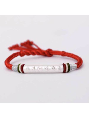 The red string protects against negative influences, while the mantra brings good luck