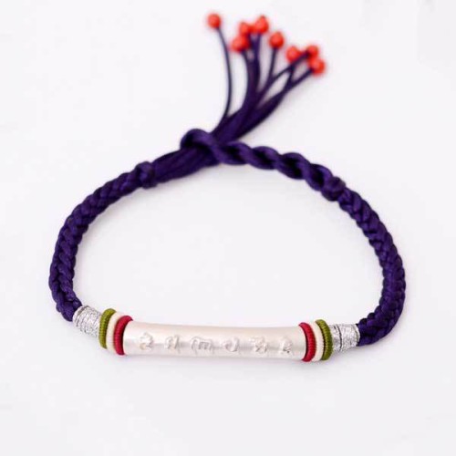 The red string protects against negative influences, while the mantra brings good luck The red string protects against negative influences, while the mantra brings good luck