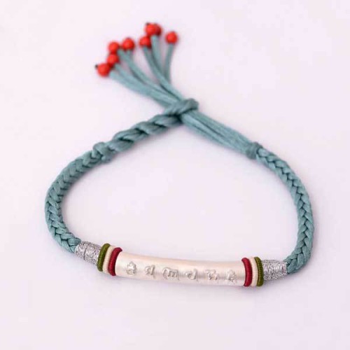 The red string protects against negative influences, while the mantra brings good luck The red string protects against negative influences, while the mantra brings good luck