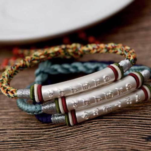 The red string protects against negative influences, while the mantra brings good luck The red string protects against negative influences, while the mantra brings good luck