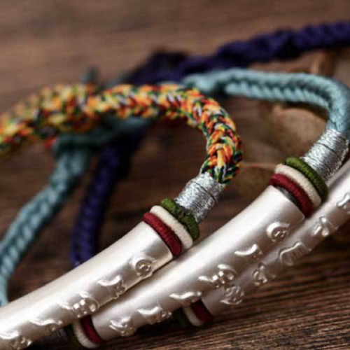The red string protects against negative influences, while the mantra brings good luck The red string protects against negative influences, while the mantra brings good luck