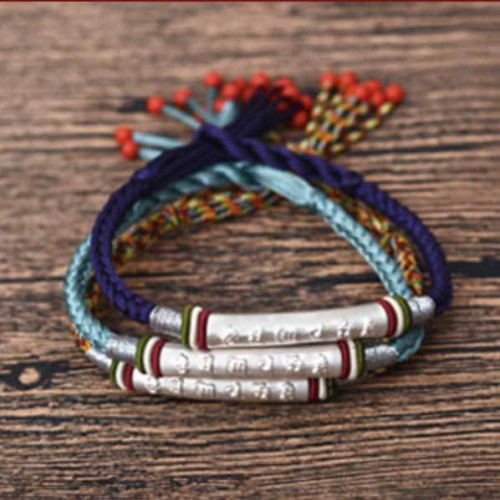 The red string protects against negative influences, while the mantra brings good luck The red string protects against negative influences, while the mantra brings good luck