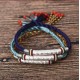 The red string protects against negative influences, while the mantra brings good luck
