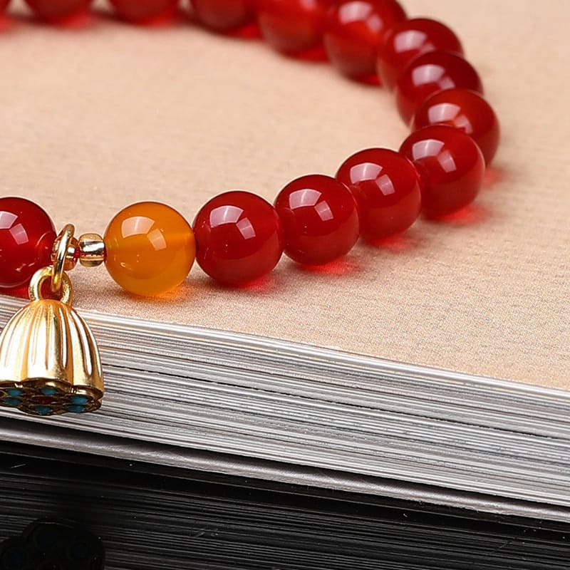 This Natural Red Agate Lotus Pod Bracelet Glows