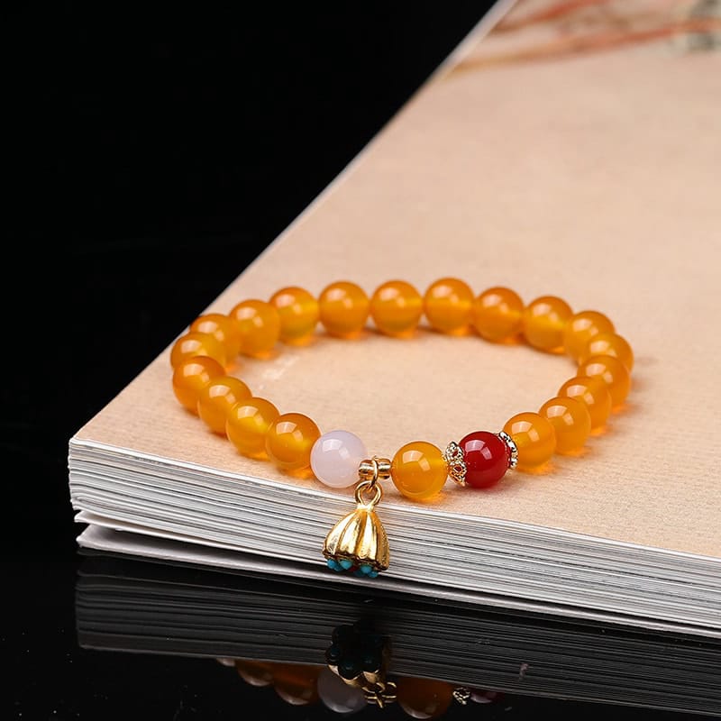 This Natural Red Agate Lotus Pod Bracelet Glows